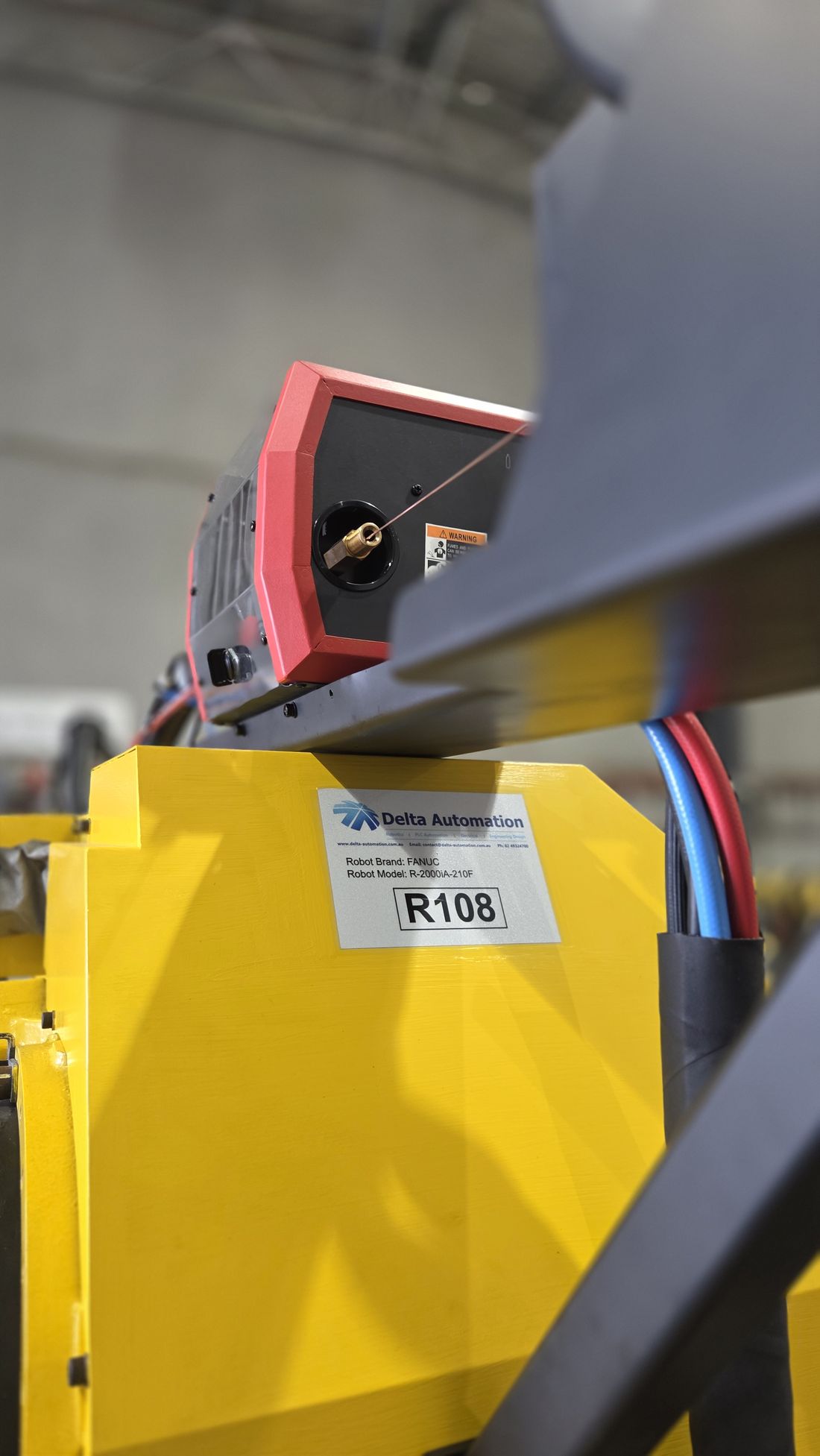 The wire feeder and power source mounted on a refurbished arm in the Rutherford workshop